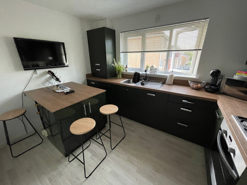 black-wrapped-kitchen-units-wooden-worktop-breakfast-bar What Backs Up Every Door-Wrapping Job We Do