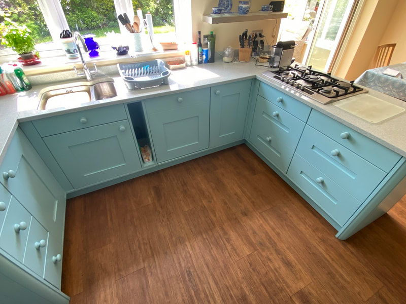 pale-blue-painted-shaker-cabinets-wood-floor What's Included When the Family Team Handles Your Kitchen
