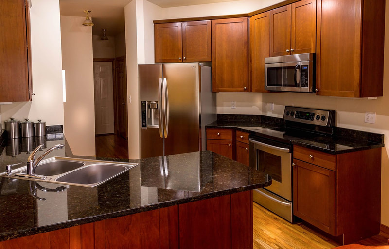 wooden-cabinets-stainless-fridge-dark-countertop Where We Make and Fit Wooden Features